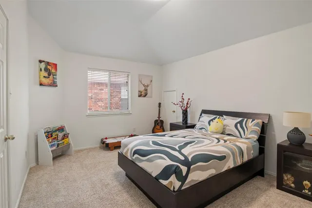 a bedroom with bed and a window