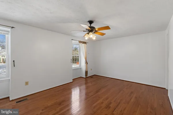 a view of a room with wooden floor and window