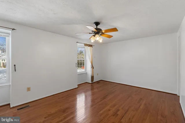 a view of a room with wooden floor and window