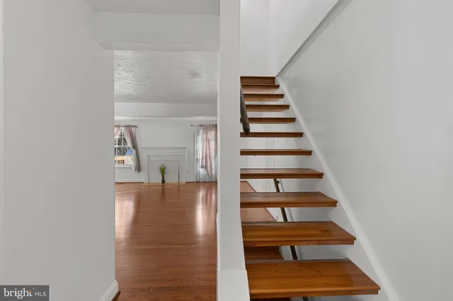 a view of entryway and hall with wooden floor