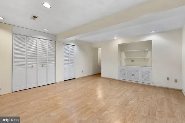 an empty room with closet area