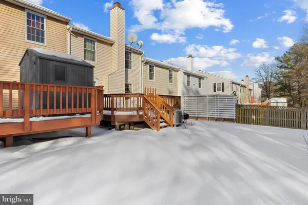 a view of a house with wooden fence