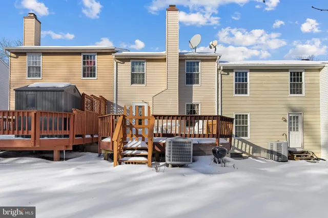 a view of a house with wooden fence