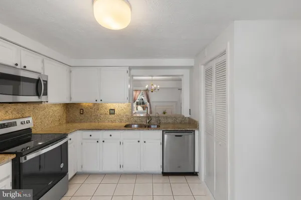 a kitchen with a sink cabinets and appliances