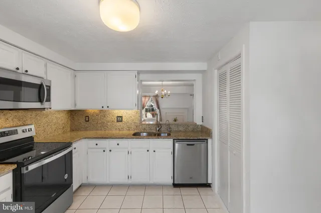 a kitchen with a sink cabinets and appliances