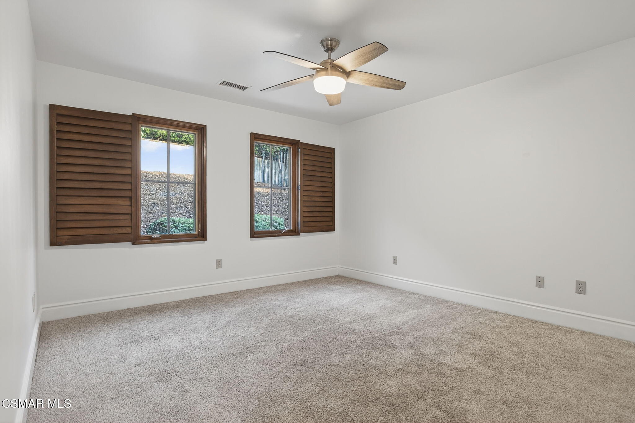 1560 Goodenough Road Fillmore, CA 93015 - Photo 41 of 81 an empty room with windows and chandelier fan