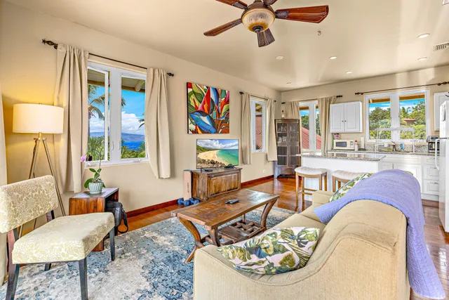 a bedroom with a bed and a lamp on the dresser