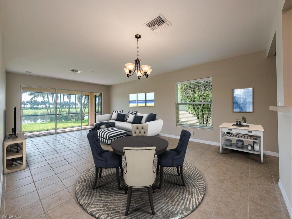 5784 Declaration Court Ave Maria, FL 34142 - Photo 2 of 21 a view of a dining room with furniture a chandelier and wooden floor