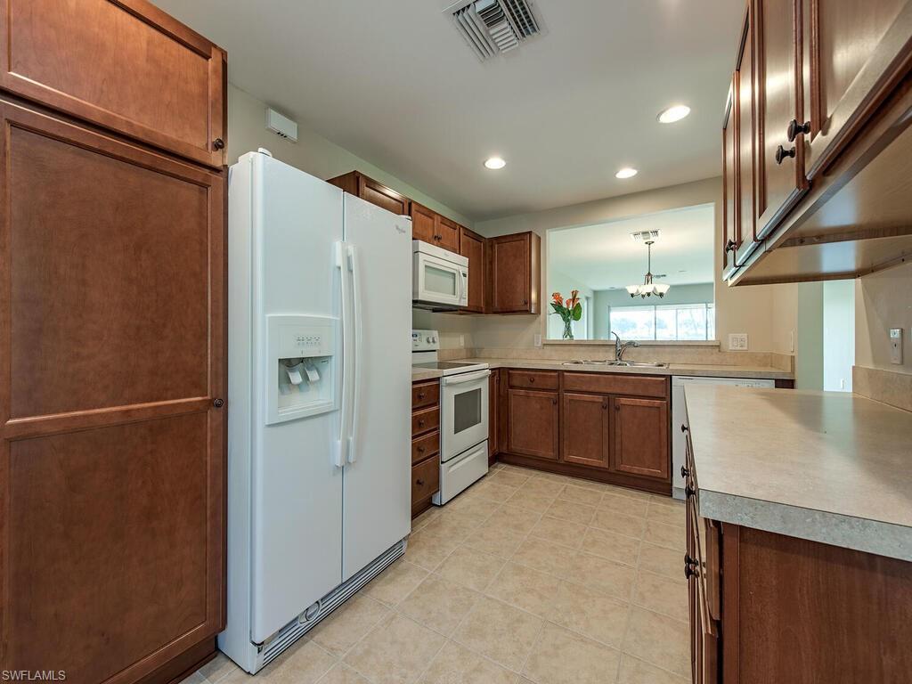 5784 Declaration Court Ave Maria, FL 34142 - Photo 3 of 21 a kitchen with stainless steel appliances a refrigerator and a sink