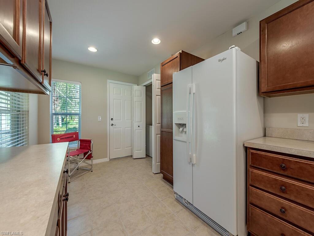 5784 Declaration Court Ave Maria, FL 34142 - Photo 4 of 21 a kitchen with stainless steel appliances granite countertop a refrigerator and a sink