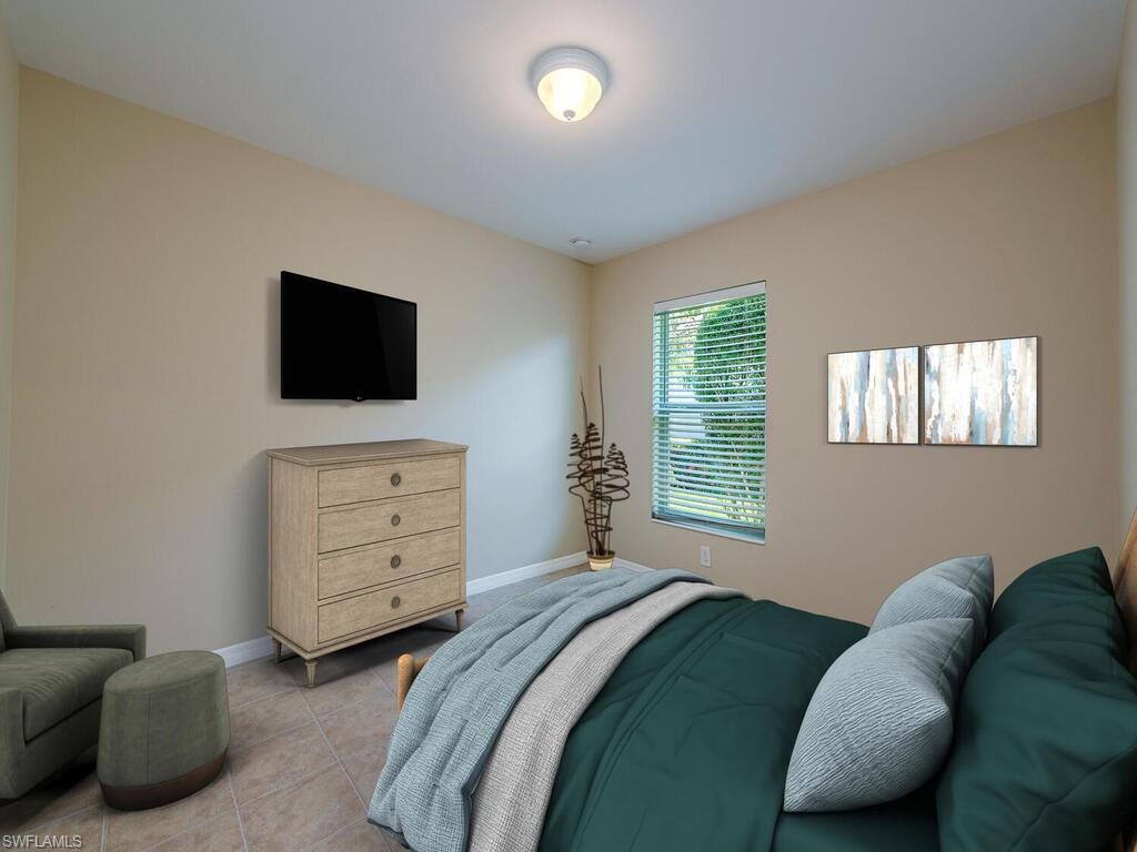 5784 Declaration Court Ave Maria, FL 34142 - Photo 7 of 21 a bedroom with a bed and a flat screen tv