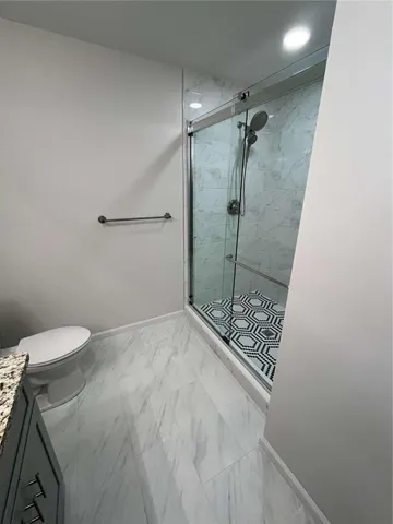 a bathroom with a shower and toilet