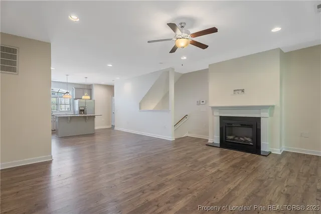 an empty room with fireplace and windows