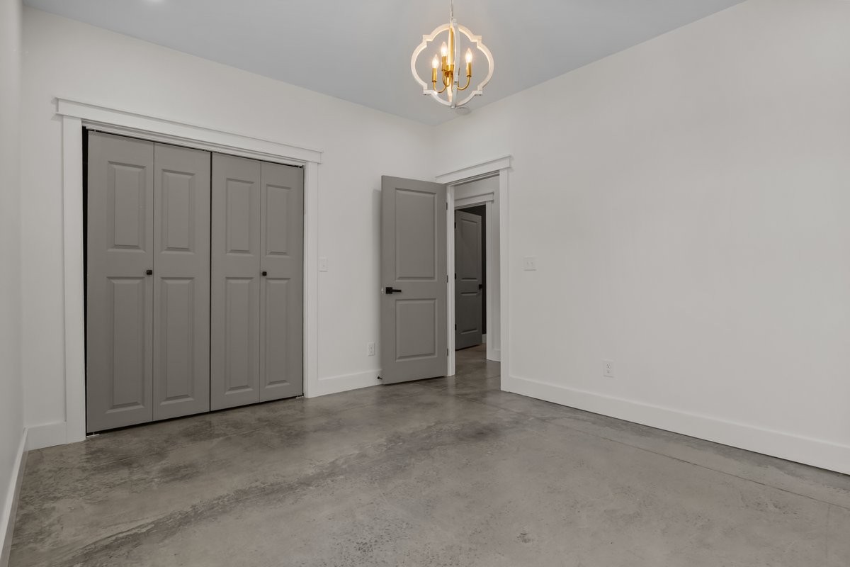 6405 Clydeton Road Waverly, TN 37185 - Photo 8 of 11 an empty room with a hallway and chandelier