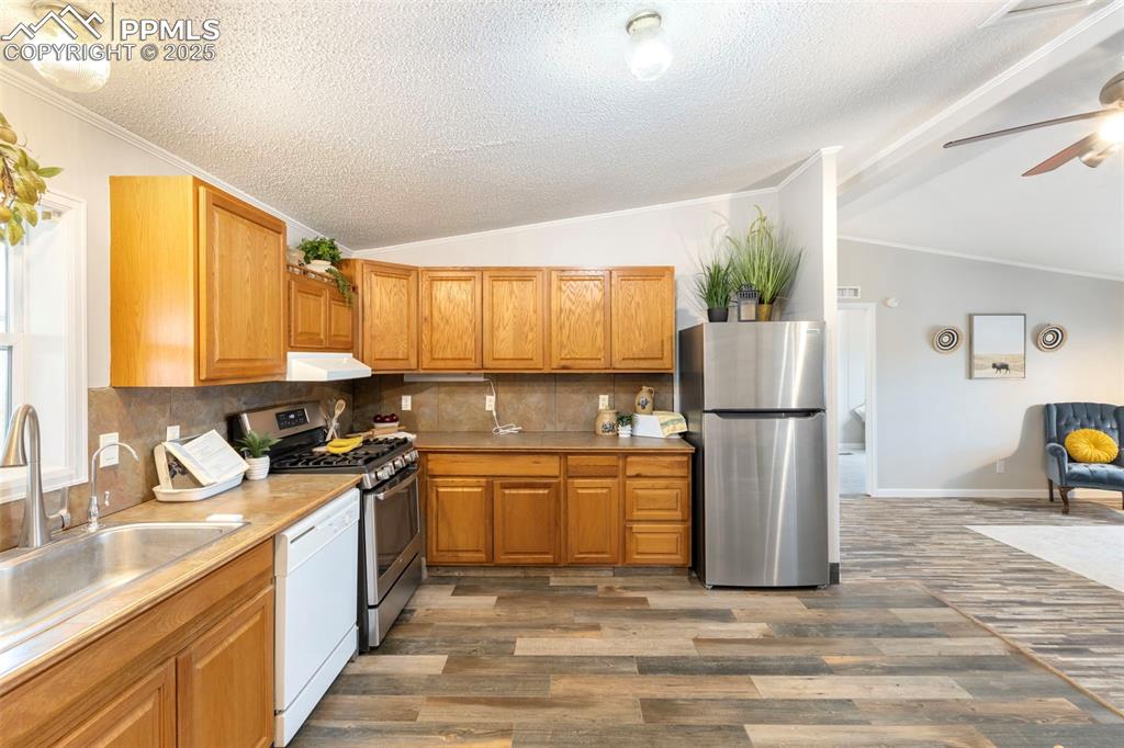 15345 Trigger Road Peyton, CO 80831 - Photo 11 of 26 a kitchen with a sink a refrigerator and a stove
