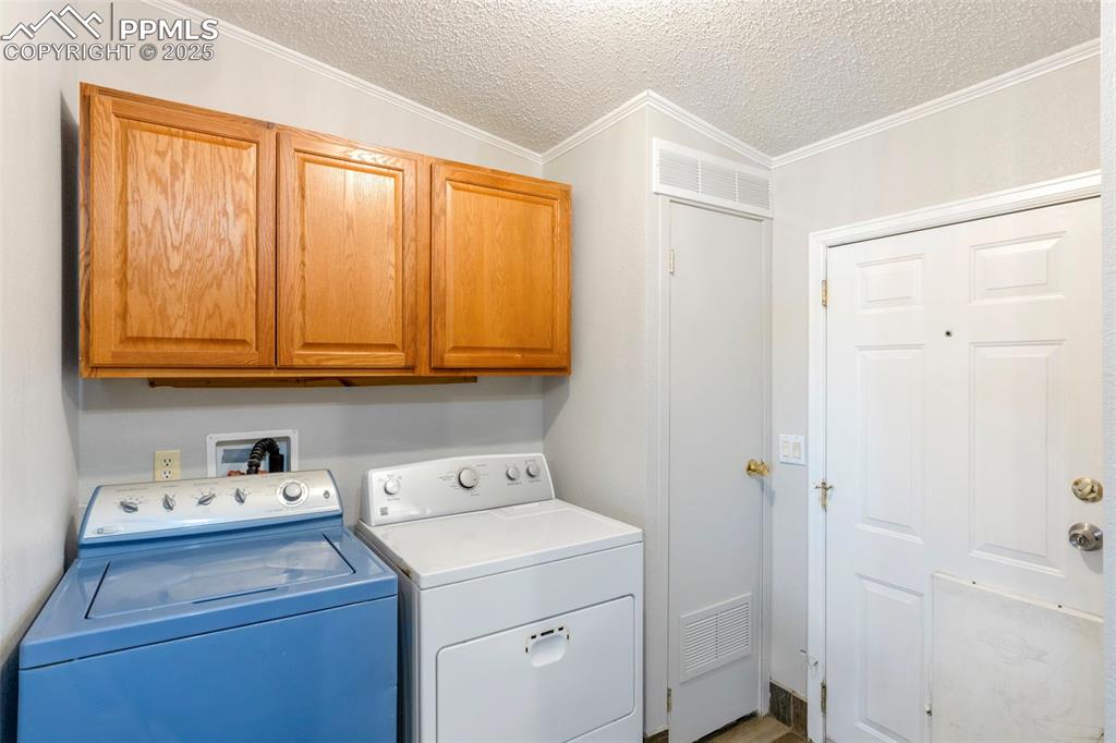 15345 Trigger Road Peyton, CO 80831 - Photo 14 of 26 a view of storage and utility room with washer and dryer