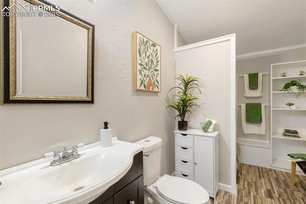 15345 Trigger Road Peyton, CO 80831 - Photo 17 of 26 a bathroom with a toilet a sink and a mirror