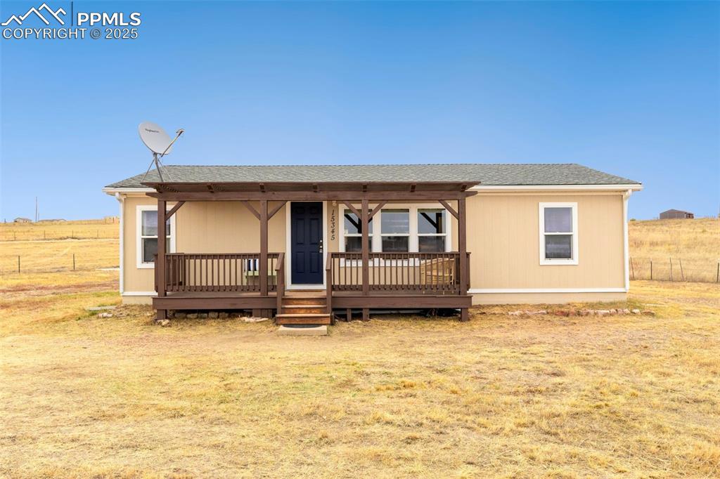 15345 Trigger Road Peyton, CO 80831 - Photo 2 of 26 a view of front of house with yard