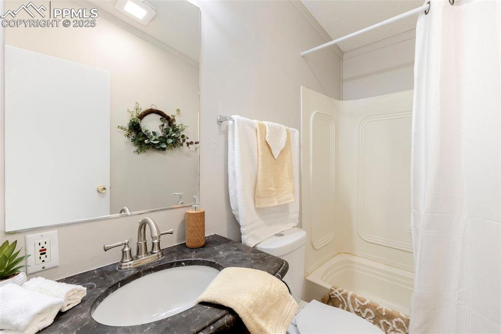 15345 Trigger Road Peyton, CO 80831 - Photo 21 of 26 a bathroom with a sink toilet and shower