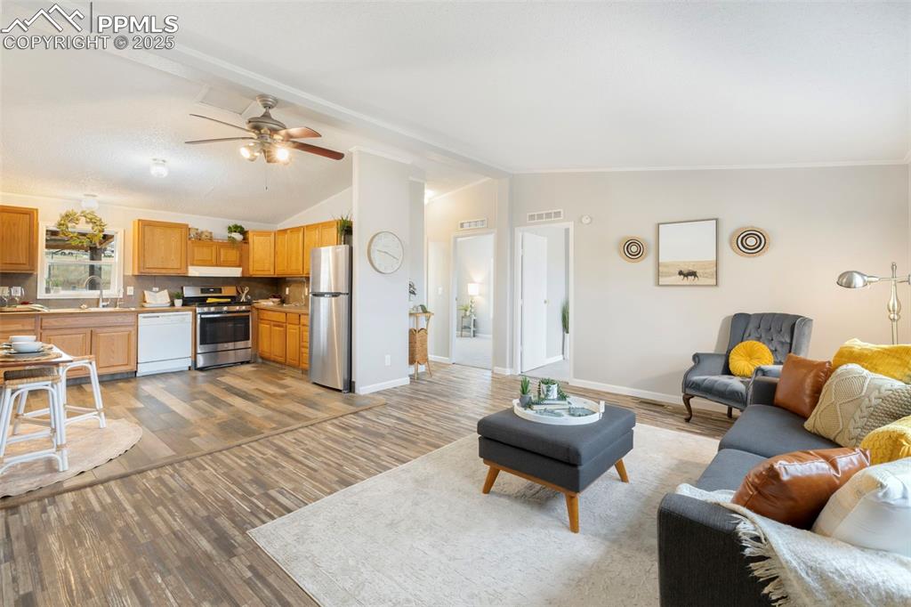 15345 Trigger Road Peyton, CO 80831 - Photo 5 of 26 a living room with furniture and a kitchen
