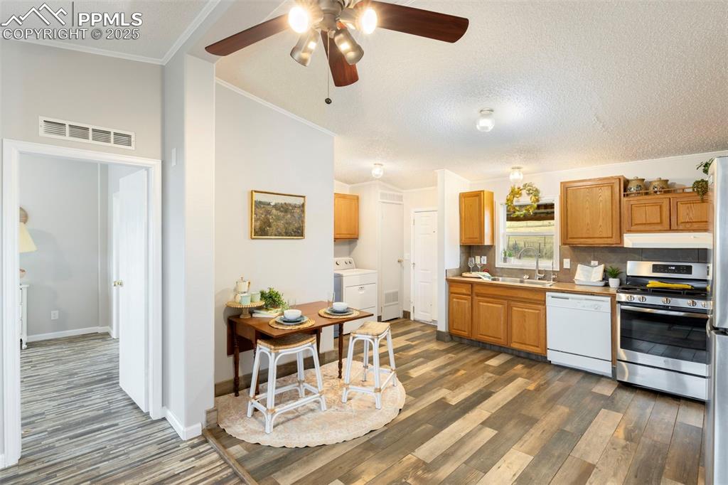 15345 Trigger Road Peyton, CO 80831 - Photo 9 of 26 a living room with stainless steel appliances kitchen island granite countertop furniture and a kitchen view