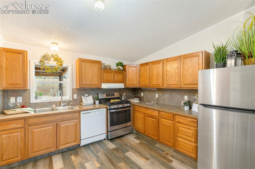 15345 Trigger Road Peyton, CO 80831 - Photo 10 of 26 a kitchen with a sink stove and refrigerator
