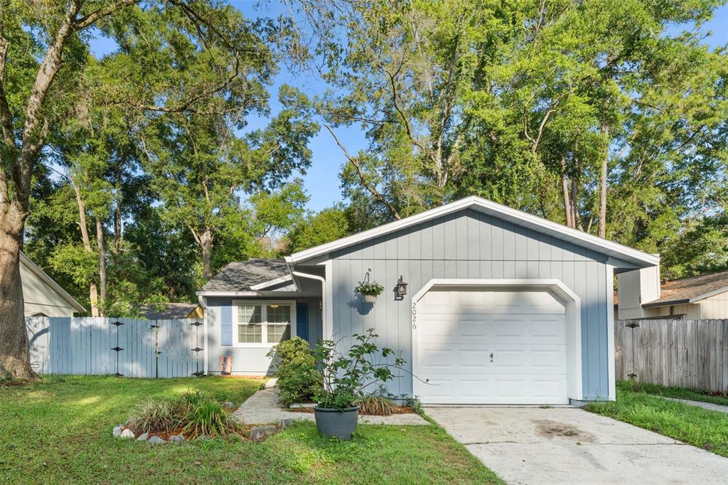 2026 Southwest 73rd Street Gainesville, FL 32607 - Photo 1 of 20 a front view of a house with a yard and garage