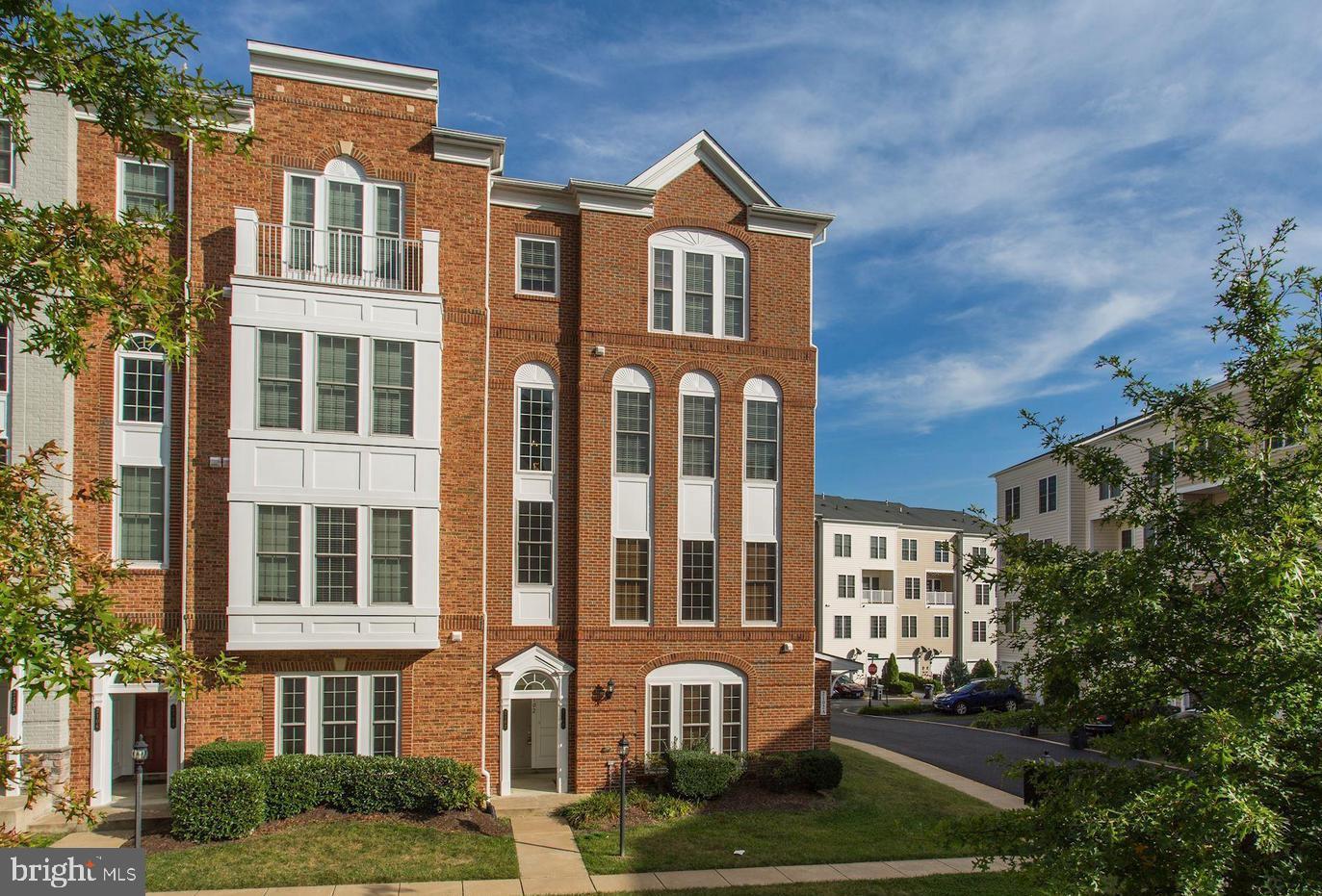 a front view of a residential apartment building with a yard
