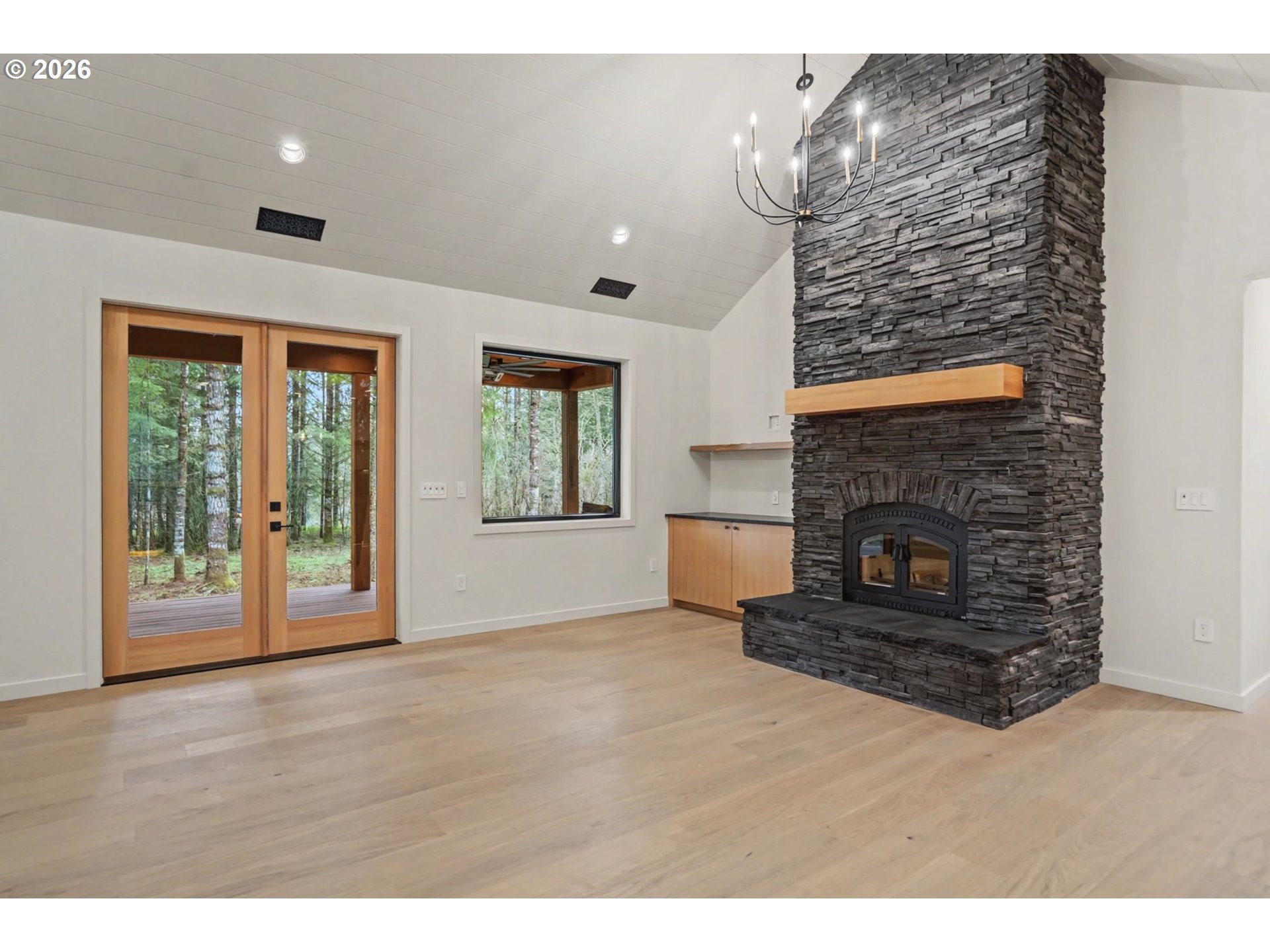19850 Winters Hill Road Southeast Silverton, OR 97381 - Photo 16 of 48 a view of an empty room with wooden floor and a fireplace