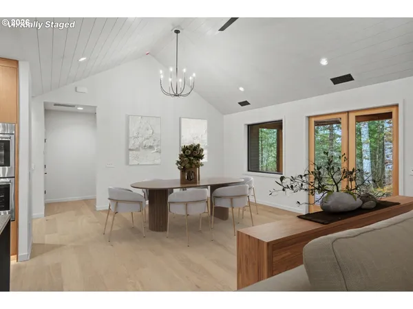 a view of a dining room with furniture wooden floor and chandelier