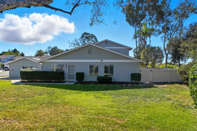 a view of a house with a yard