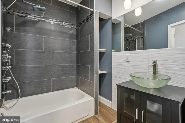 a bathroom with a bathtub and a sink