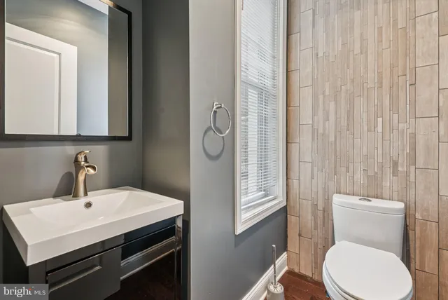 a bathroom with a toilet a sink and mirror