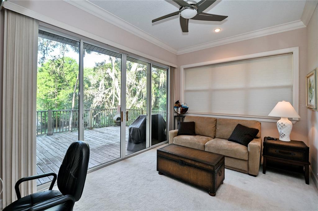 2299 North Bayou Point Inverness, FL 34453 - Photo 20 of 64 a living room with furniture and a floor to ceiling window