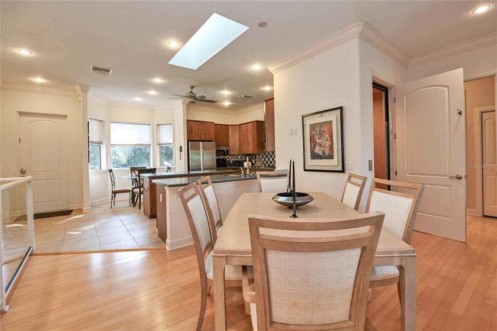 2299 North Bayou Point Inverness, FL 34453 - Photo 26 of 64 a kitchen with stainless steel appliances granite countertop a table chairs and a refrigerator