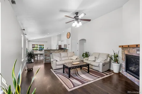 a living room with furniture a fireplace and a chandelier