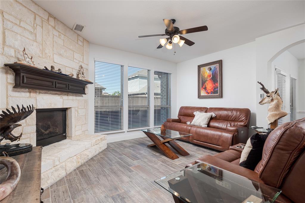 1008 Hummingbird Court Forney, TX 75126 - Photo 10 of 34 a living room with furniture and a fireplace
