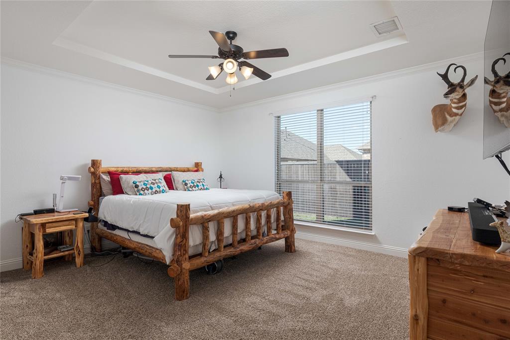 1008 Hummingbird Court Forney, TX 75126 - Photo 12 of 34 a bed sitting in a bedroom next to a window