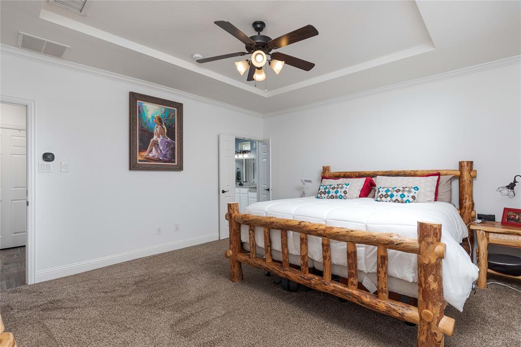 1008 Hummingbird Court Forney, TX 75126 - Photo 13 of 34 a bedroom with a bed and a chandelier