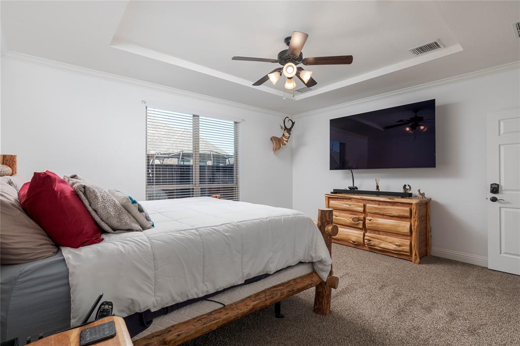 1008 Hummingbird Court Forney, TX 75126 - Photo 14 of 34 a bedroom with a bed and a flat screen tv
