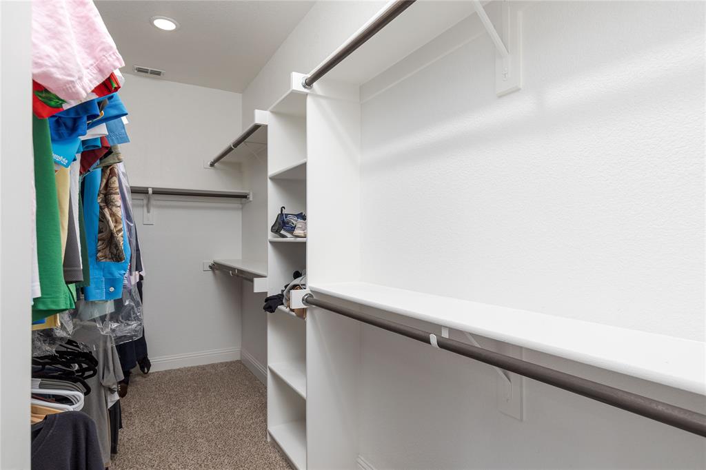 1008 Hummingbird Court Forney, TX 75126 - Photo 17 of 34 a view of walk in closet with clothes