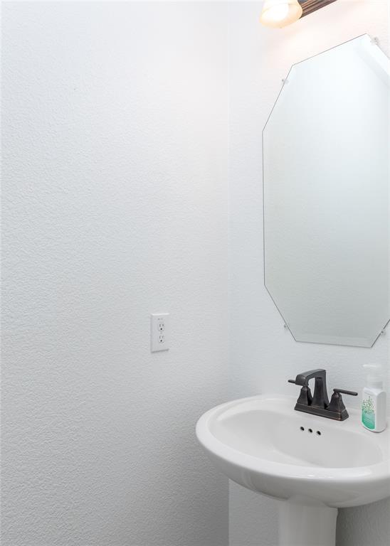 1008 Hummingbird Court Forney, TX 75126 - Photo 27 of 34 a bathroom with a sink and a mirror