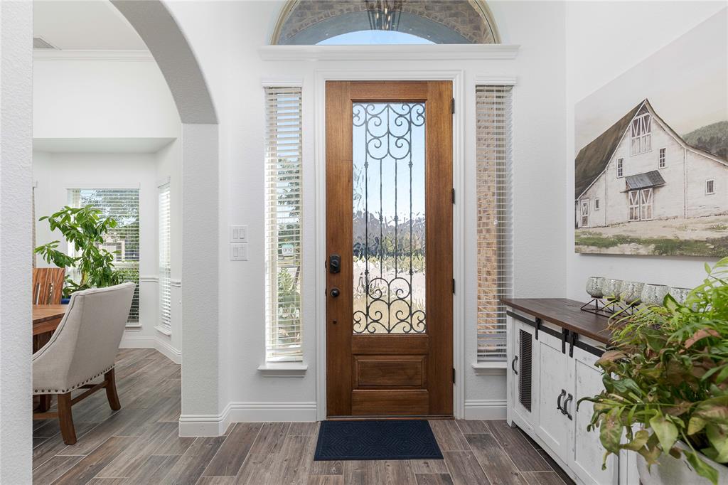 1008 Hummingbird Court Forney, TX 75126 - Photo 3 of 34 a hallway with a dining table and chairs