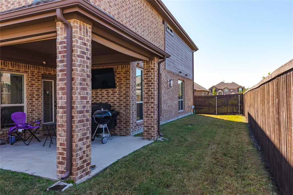 1008 Hummingbird Court Forney, TX 75126 - Photo 30 of 34 a view of a house with backyard and porch