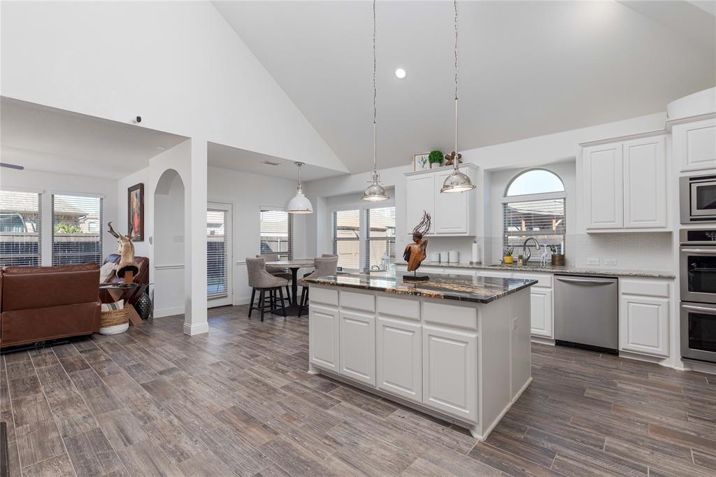 1008 Hummingbird Court Forney, TX 75126 - Photo 34 of 34 a open kitchen with stainless steel appliances granite countertop a lot of counter space and wooden floors