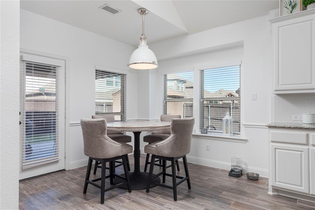 1008 Hummingbird Court Forney, TX 75126 - Photo 8 of 34 a view of a dining room with furniture window and wooden floor