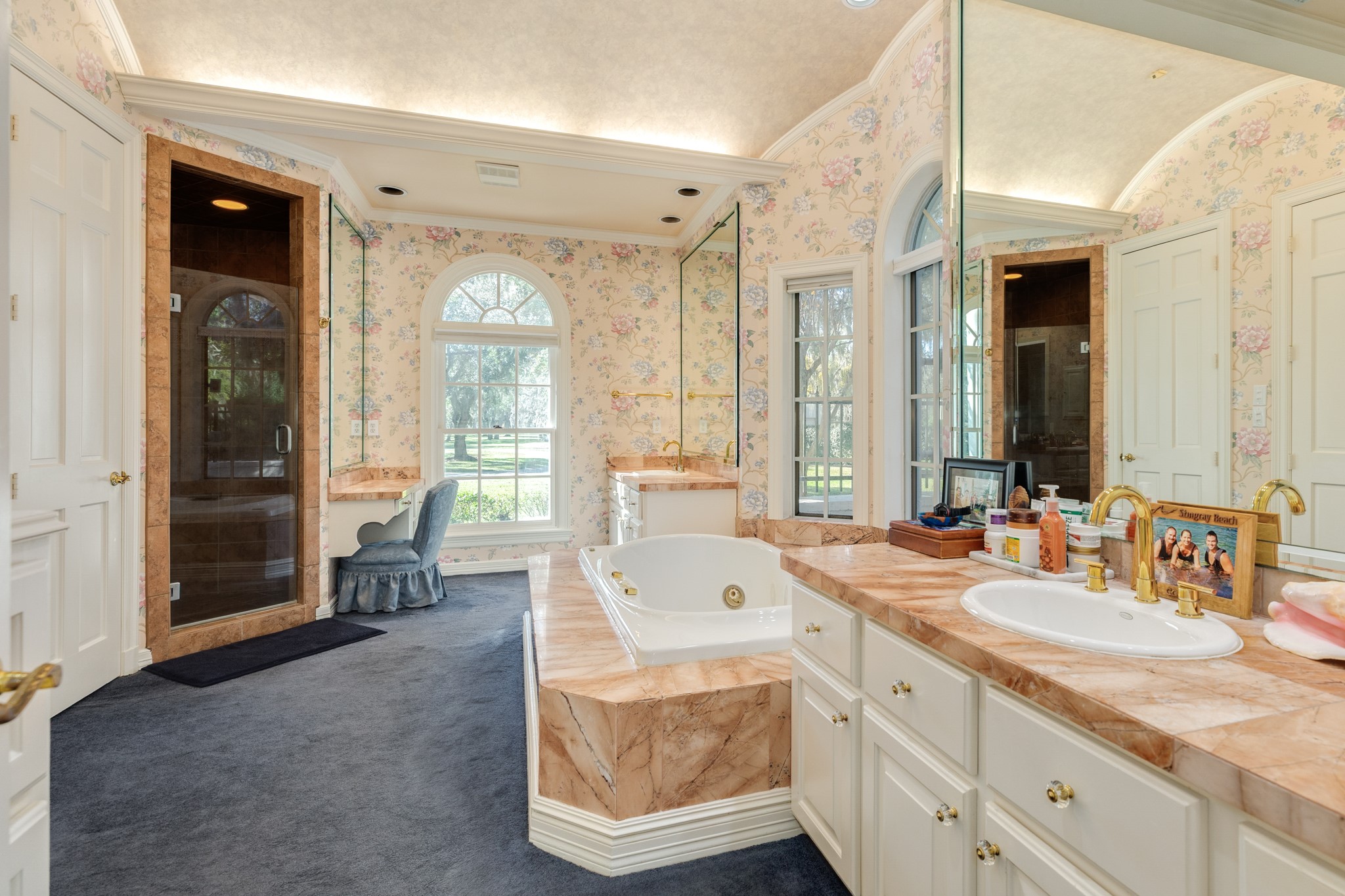 3 Bayou Road Lake Jackson, TX 77566 - Photo 29 of 50 a spacious bathroom with a double vanity sink large mirror and a bathtub