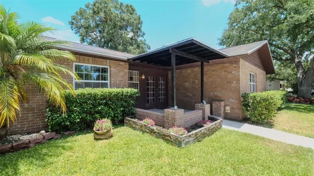 a view of an house with backyard space and porch