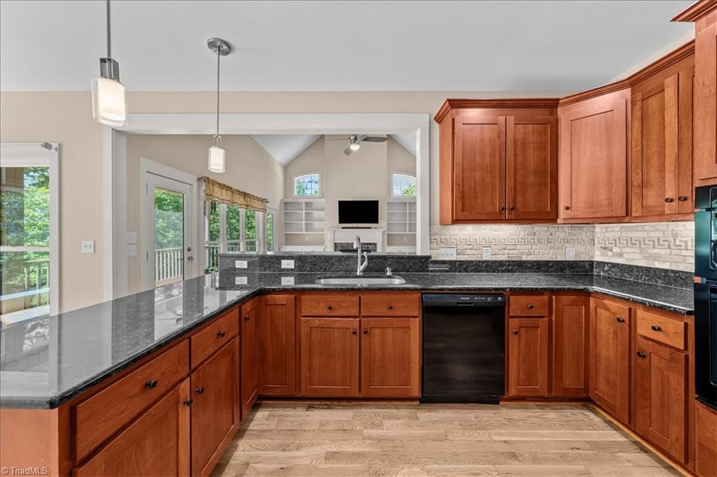 848 Sierra Trace Road Denton, NC 27239 - Photo 20 of 47 Spacious kitchen featuring granite countertops, rich cabinetry, stainless appliances, and a functional island with bar seating.