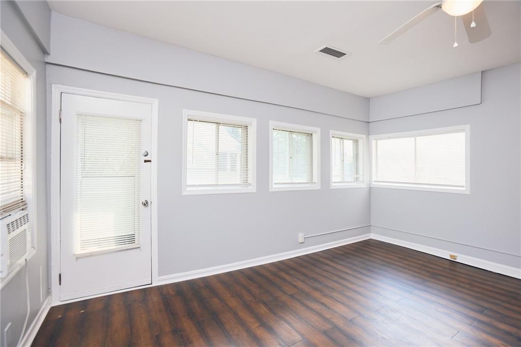 887 Myrtle Street Northeast, Unit 5 Atlanta, GA 30309 - Photo 6 of 11 an empty room with wooden floor and windows